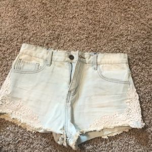 Light Wash jean shorts with lace pattern on sides